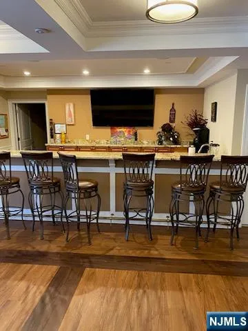 a kitchen with stainless steel appliances kitchen island granite countertop a table chairs stove and cabinets