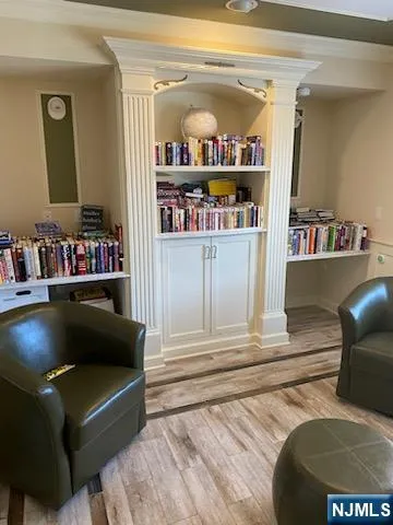 a living room with furniture and a shelf