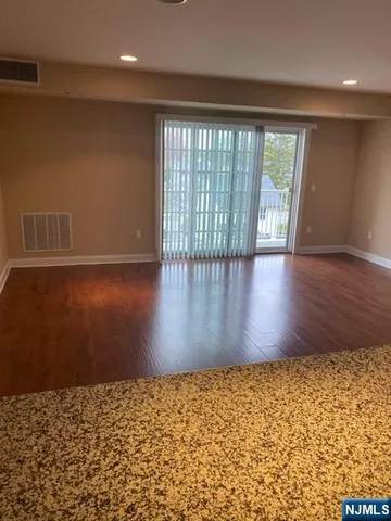 a view of wooden floor and brick walls