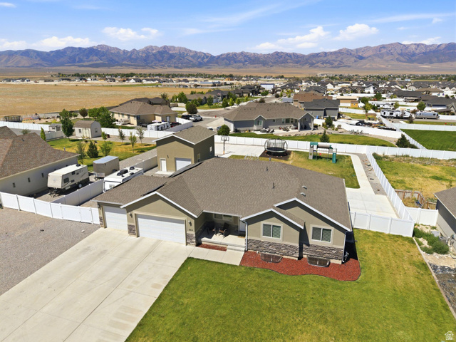 664 South Saddle Road Grantsville, UT 84029 - Photo 3 of 78 Ranch-style residence featuring a two-car garage, stone veneer accents, and a covered porch