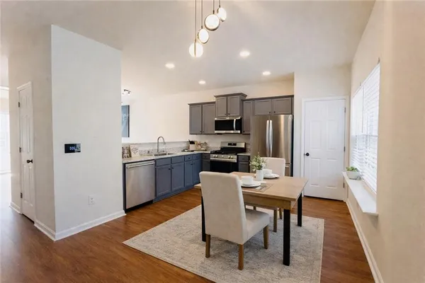 a view of a dining room with furniture and wooden floor