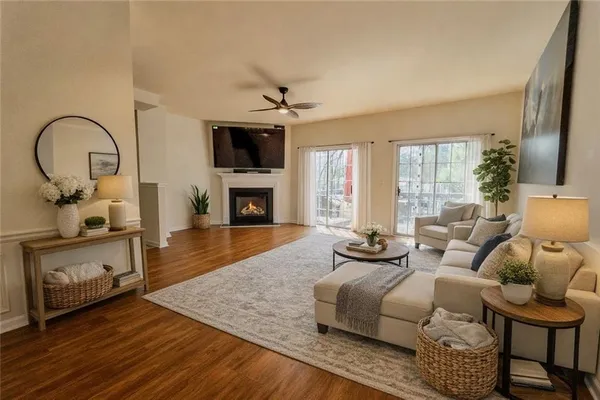 a living room with furniture a fireplace and a flat screen tv