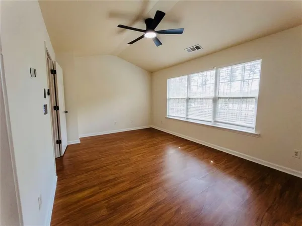 wooden floor in an empty room with a window
