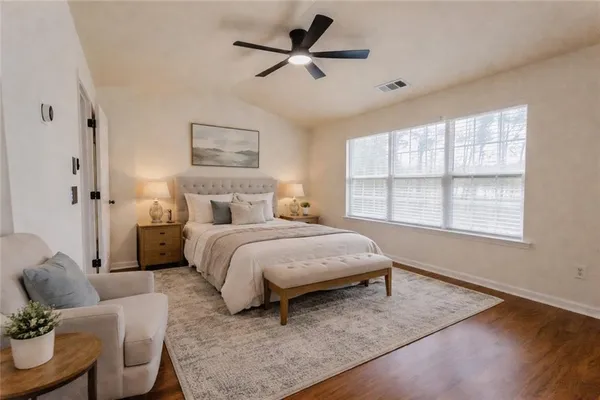 a bedroom with a bed and a window