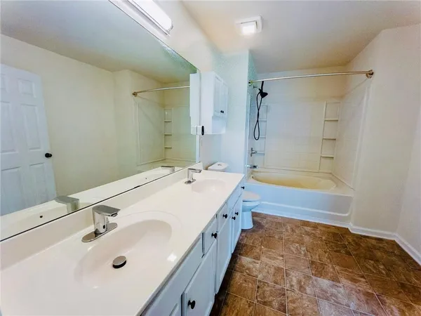 a bathroom with a tub sink and mirror