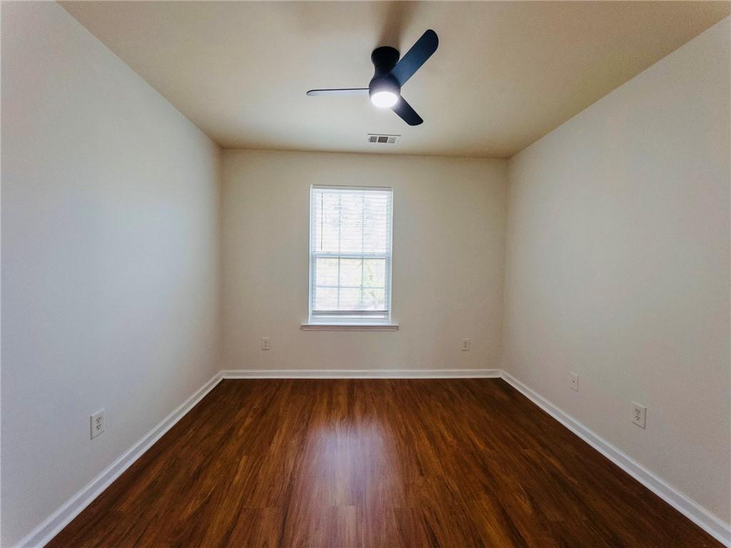 3658 Utoy Drive Southwest Atlanta, GA 30331 - Photo 22 of 28 wooden floor in an empty room with a window