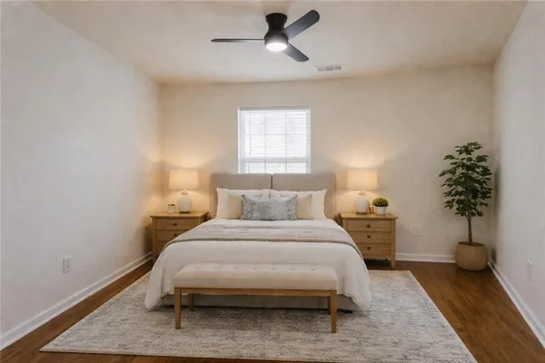 a bedroom with a bed and a potted plant