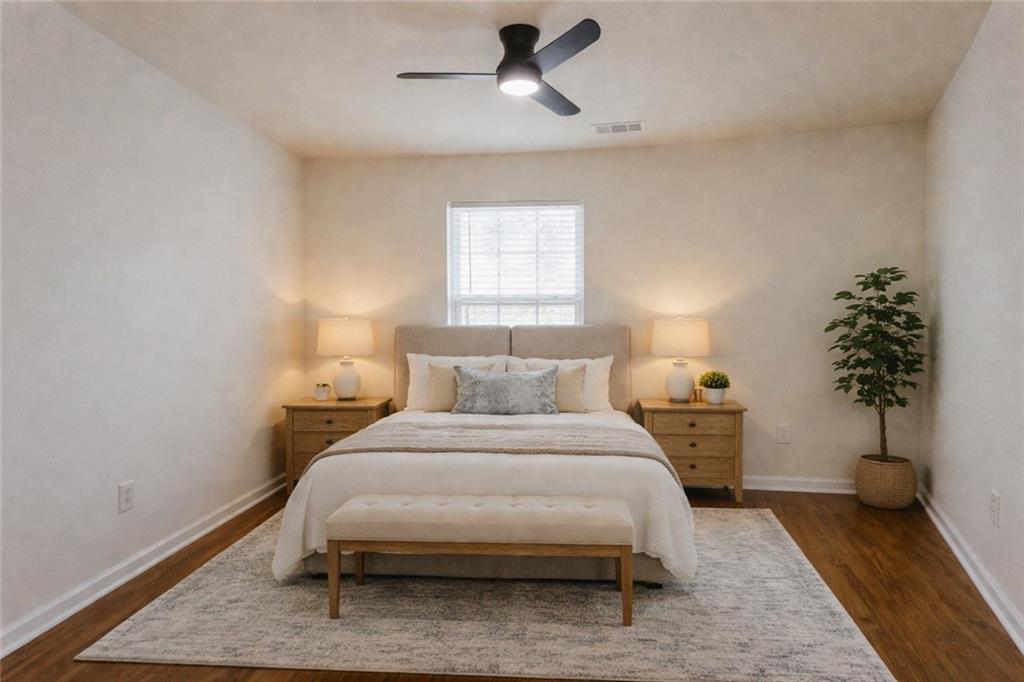 3658 Utoy Drive Southwest Atlanta, GA 30331 - Photo 23 of 28 a bedroom with a bed and a potted plant