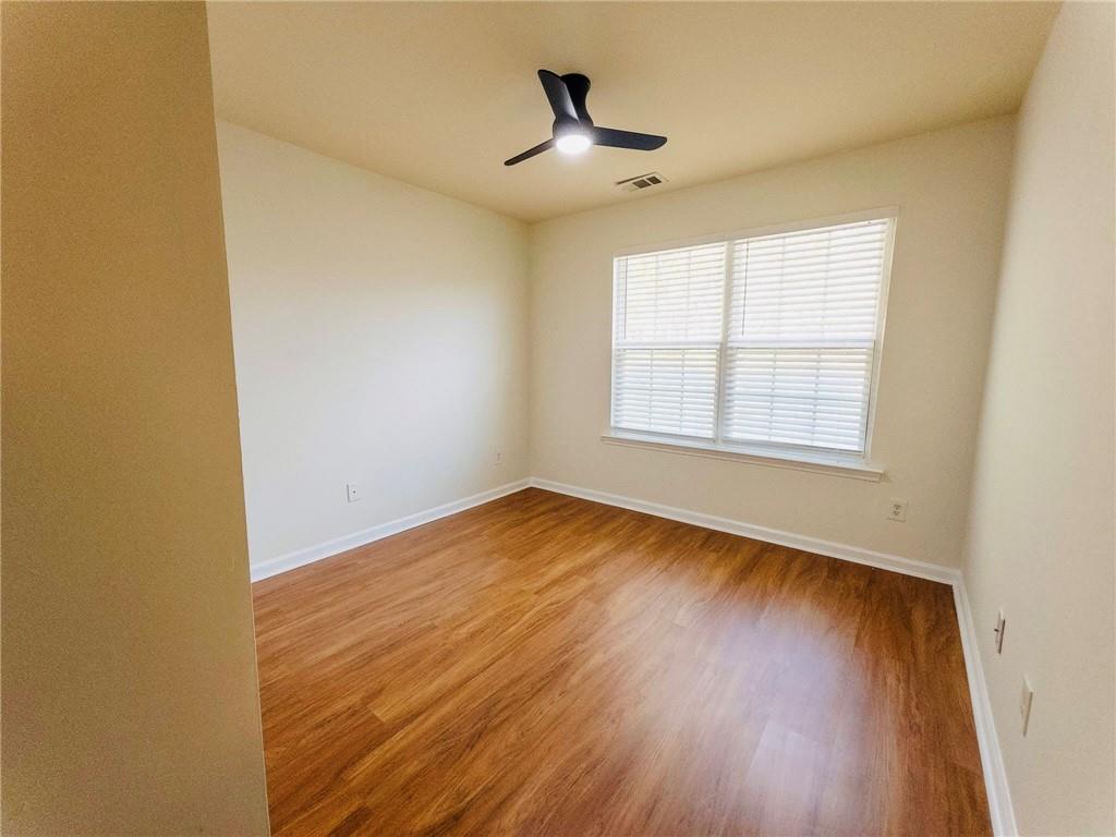 3658 Utoy Drive Southwest Atlanta, GA 30331 - Photo 24 of 28 an empty room with wooden floor and windows