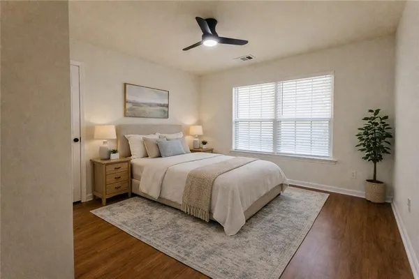 a bedroom with a large bed and a chandelier
