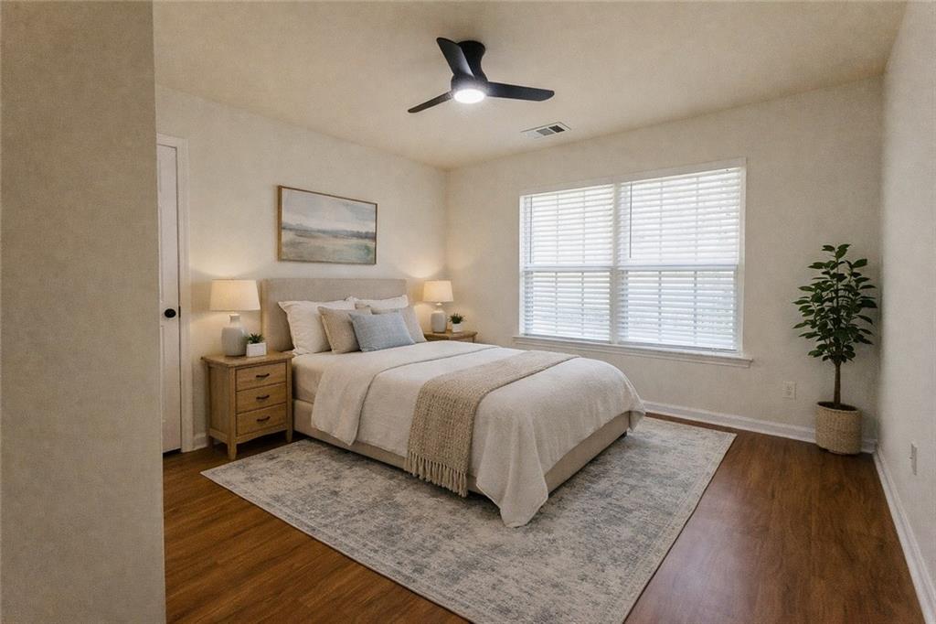 3658 Utoy Drive Southwest Atlanta, GA 30331 - Photo 25 of 28 a bedroom with a large bed and a chandelier