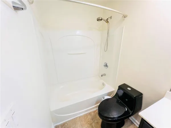 a bathroom with a bathtub and a toilet