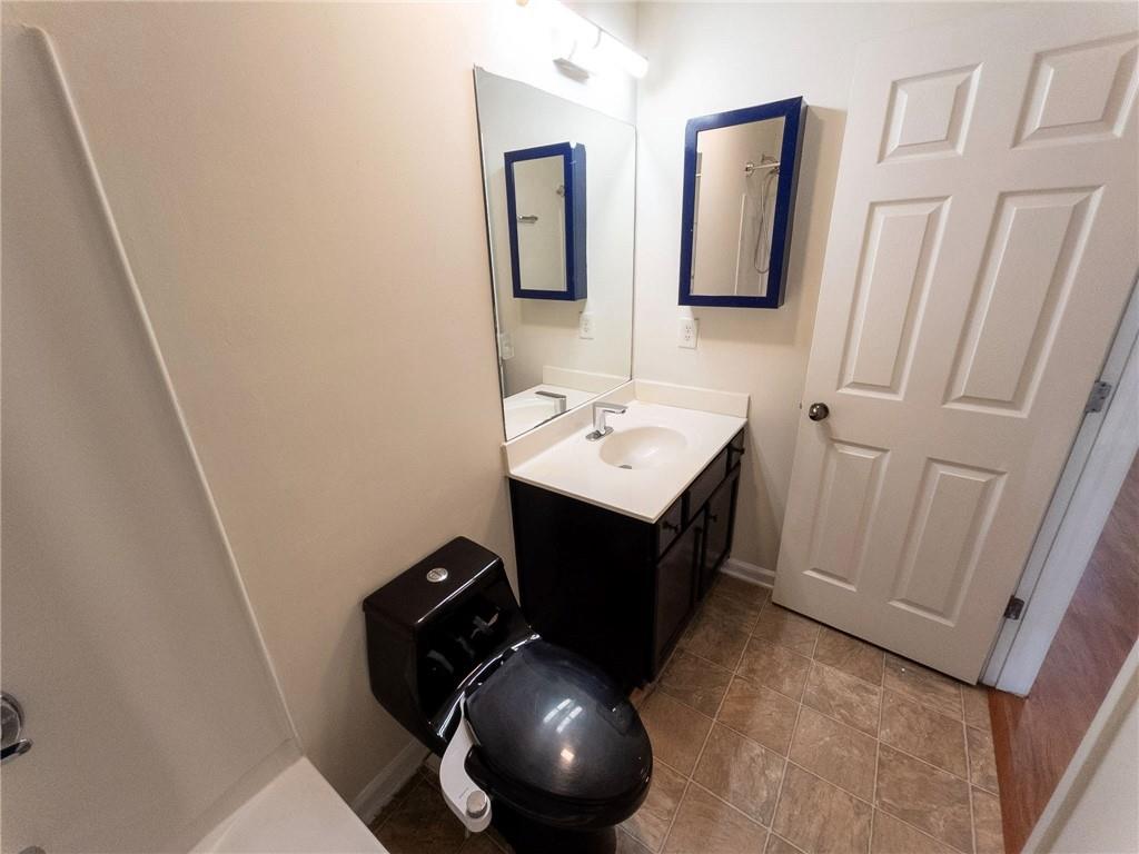 3658 Utoy Drive Southwest Atlanta, GA 30331 - Photo 28 of 28 a bathroom with a toilet sink and mirror