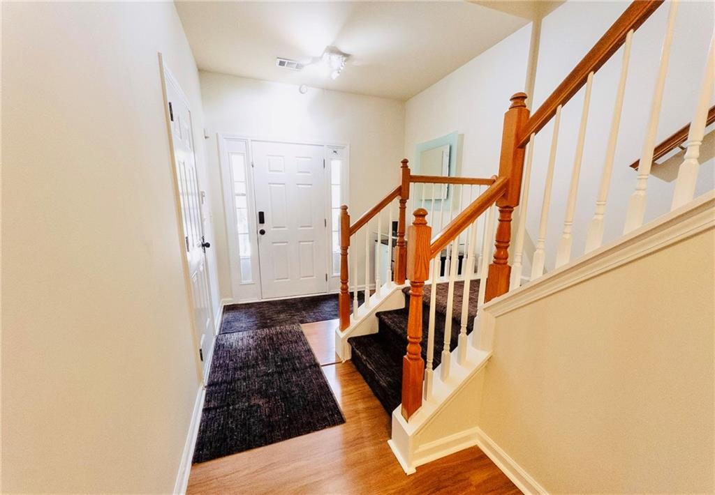 3658 Utoy Drive Southwest Atlanta, GA 30331 - Photo 7 of 28 a view of a hallway with wooden floor and staircase