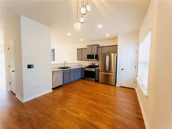 a kitchen with stainless steel appliances a refrigerator and a sink
