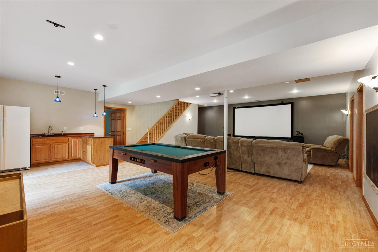 6050 Dry Ridge Road Cincinnati, OH 45252 - Photo 41 of 57 Lower level rec room features laminate flooring, wet bar, recessed and pendulum lighting.