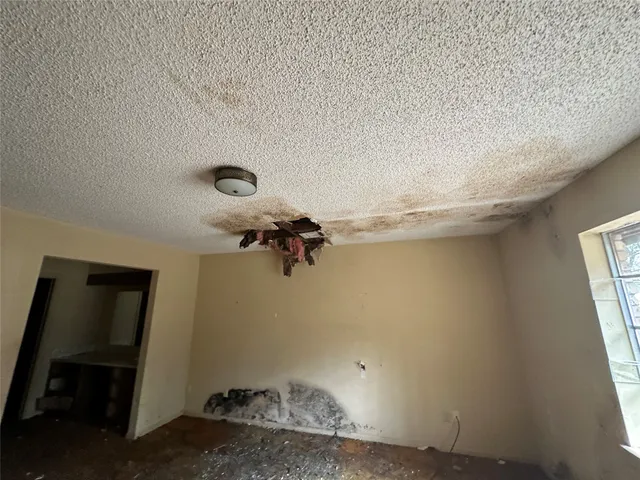 a room with furniture cabinetry and window