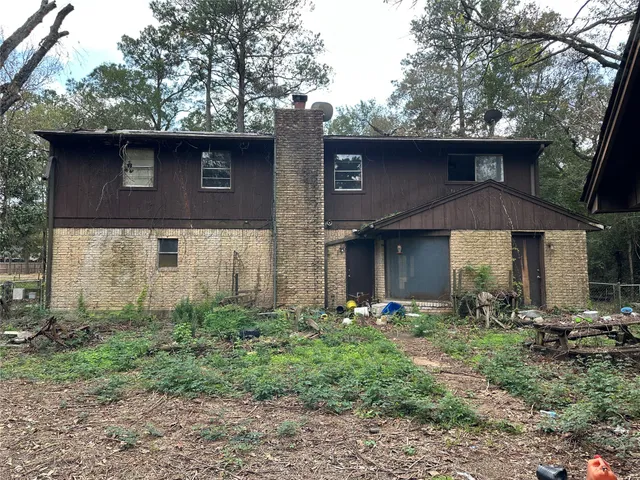 a living room with furniture and large windows