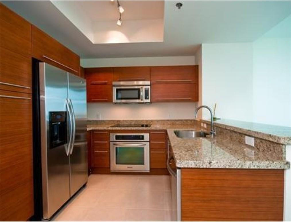 2681 North Flamingo Road, Unit 504 Sunrise, FL 33323 - Photo 4 of 13 a kitchen with stainless steel appliances granite countertop a sink and a stove