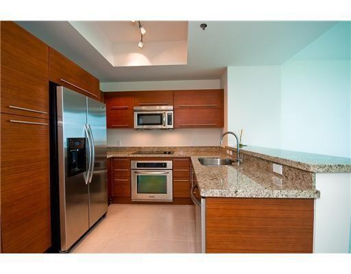 2681 North Flamingo Road, Unit 504 Sunrise, FL 33323 - Photo 10 of 13 a kitchen with stainless steel appliances granite countertop a sink stove and refrigerator