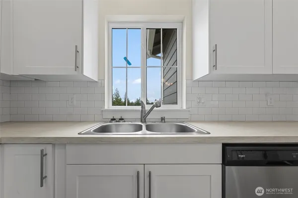 a kitchen with a sink and cabinets