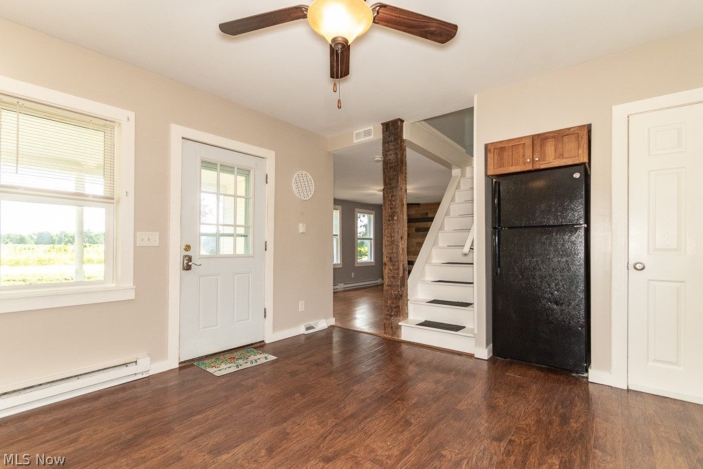 16506 Leroy Thompson Road Thompson, OH 44086 - Photo 32 of 41 Entryway featuring dark wood-type flooring, baseboard heating, a wealth of natural light, and ceiling fan