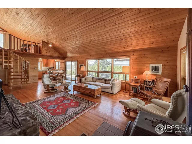 a living room with furniture a rug and a table
