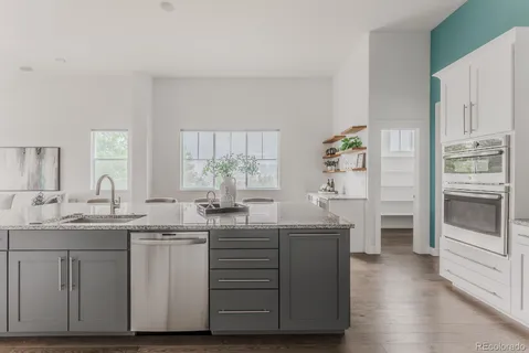 a kitchen with stainless steel appliances a sink and cabinets