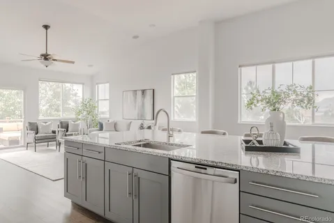 a kitchen with sink a window and cabinets