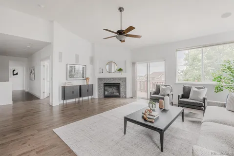 a living room with furniture a fireplace and a table