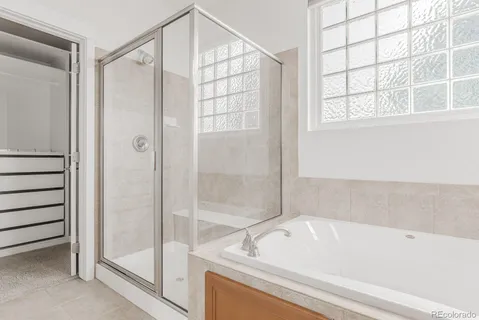 a bathroom with a bathtub and a shower
