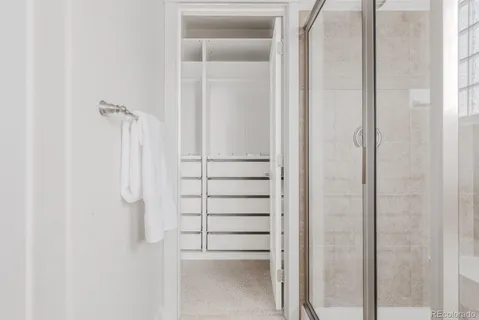 a bathroom with a glass door shower