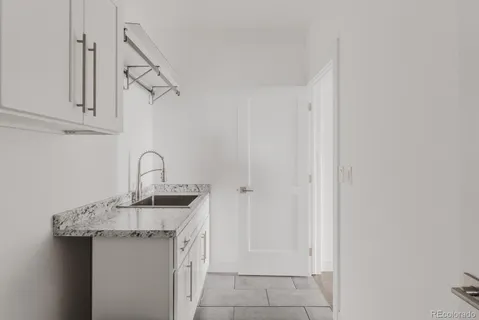 a kitchen with stainless steel appliances granite countertop a sink and cabinets