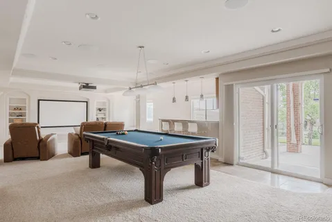 a room with furniture pool table and flat screen tv