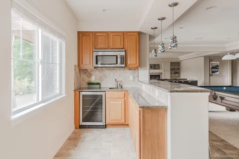 a kitchen with stainless steel appliances kitchen island granite countertop a stove and a sink