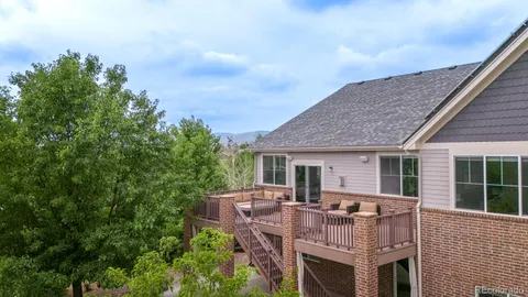 a view of a deck with table and chairs with wooden floor and fence