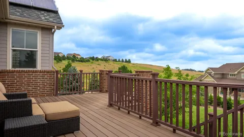 a view of a balcony with wooden floor and outdoor space