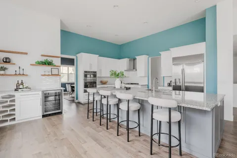 a large kitchen with a table and chairs