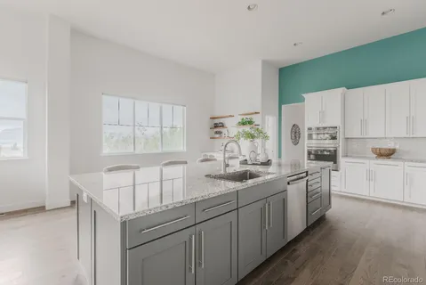 a kitchen with appliances a sink and cabinets
