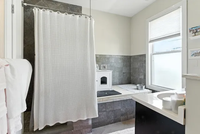a bathroom with a sink a mirror and a shower
