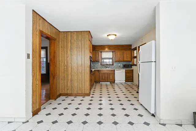 a kitchen with a refrigerator and cabinets