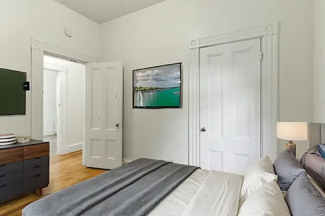 a bedroom with a bed and a flat screen tv