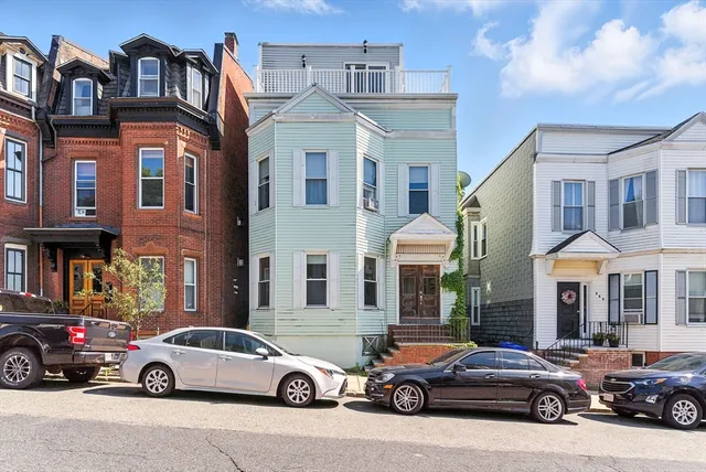 a car parked in front of a building and cars parked in front of a building