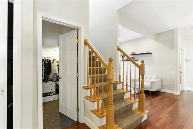 a view of entryway and hall with wooden floor
