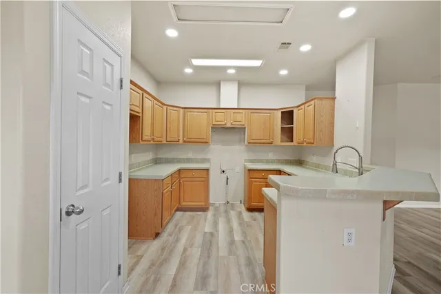 a kitchen with a sink a refrigerator and a stove top oven
