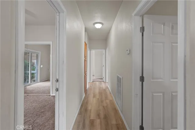 a view of a hallway with wooden floor