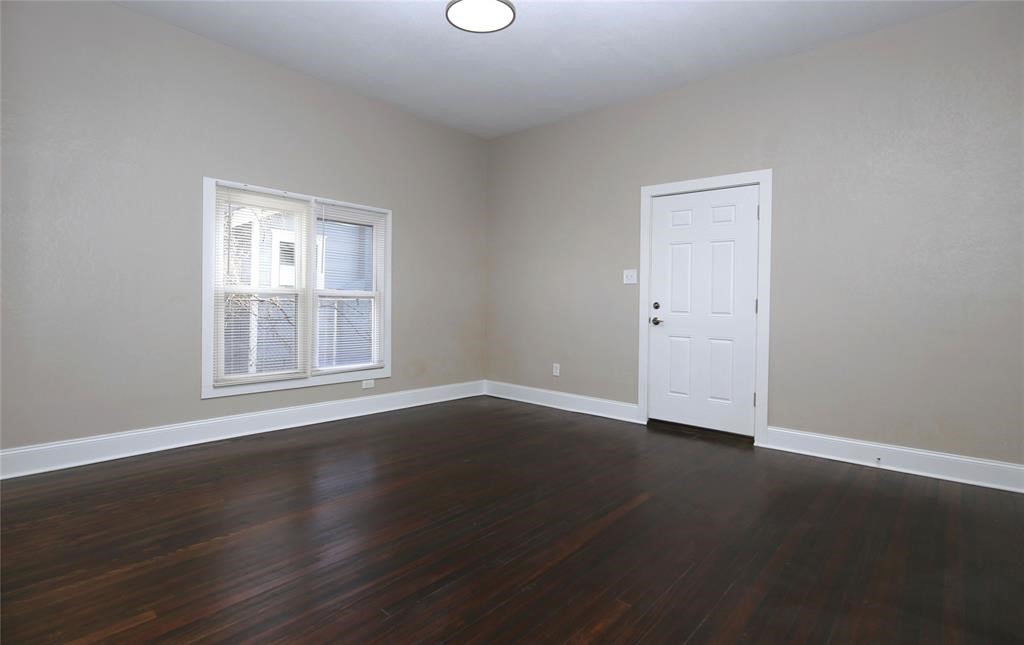 4445 Rusk Street Houston, TX 77023 - Photo 21 of 50 Unit #2 bedroom with fresh paint, light fixtures, and refinished hardwood original floors.