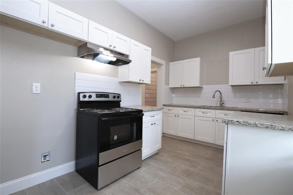 4445 Rusk Street Houston, TX 77023 - Photo 25 of 50 Unit #2 kitchen offers contemporary finishes, custom cabinetry, granite counters, SS appliances, and backsplash.