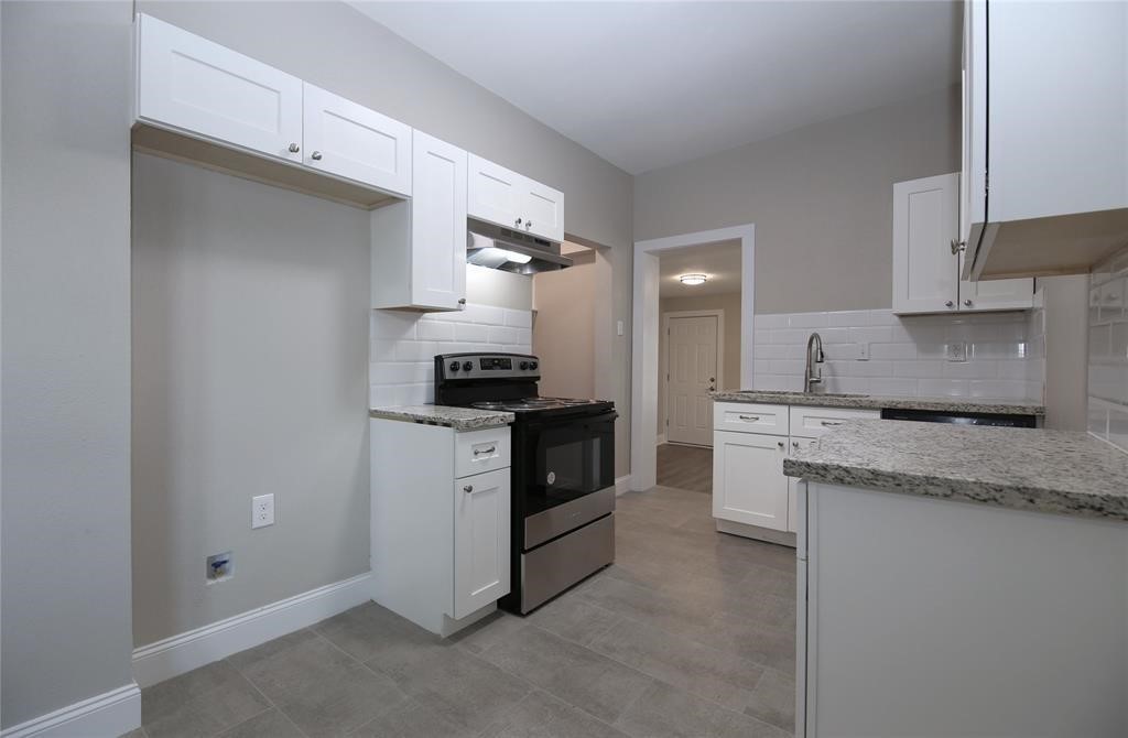 4445 Rusk Street Houston, TX 77023 - Photo 42 of 50 Unit #4 kitchen features granite counters, custom cabinets, stainless steel appliances and ceramic tile floors.