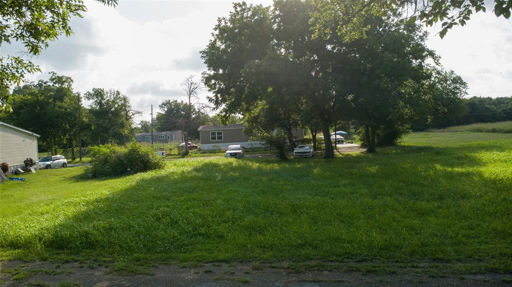 103 Atlantic Street Cleburne, TX 76031 - Photo 3 of 5 Expansive grassy lot with mature trees providing partial shade